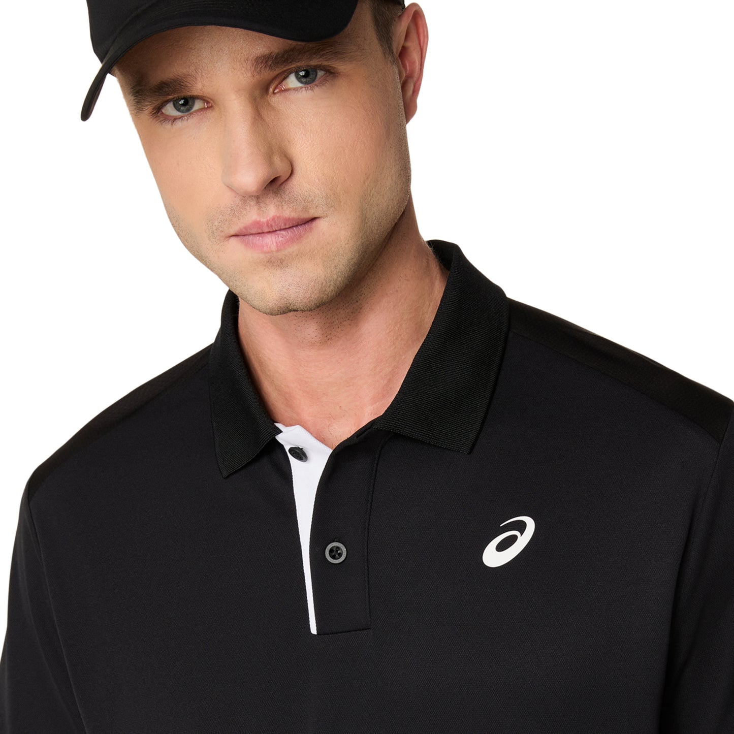 Man wearing a black polo shirt with a logo on a white background