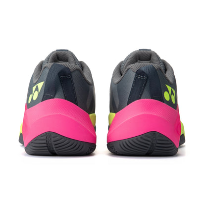 Gray Yonex squash shoes with pink and yellow accents on a white background