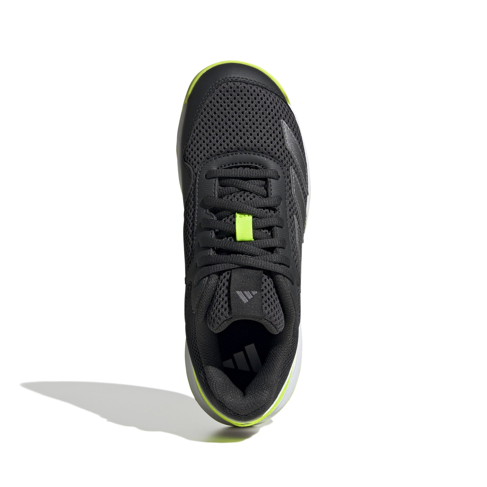 Black Adidas tennis shoe with green accents on a white background