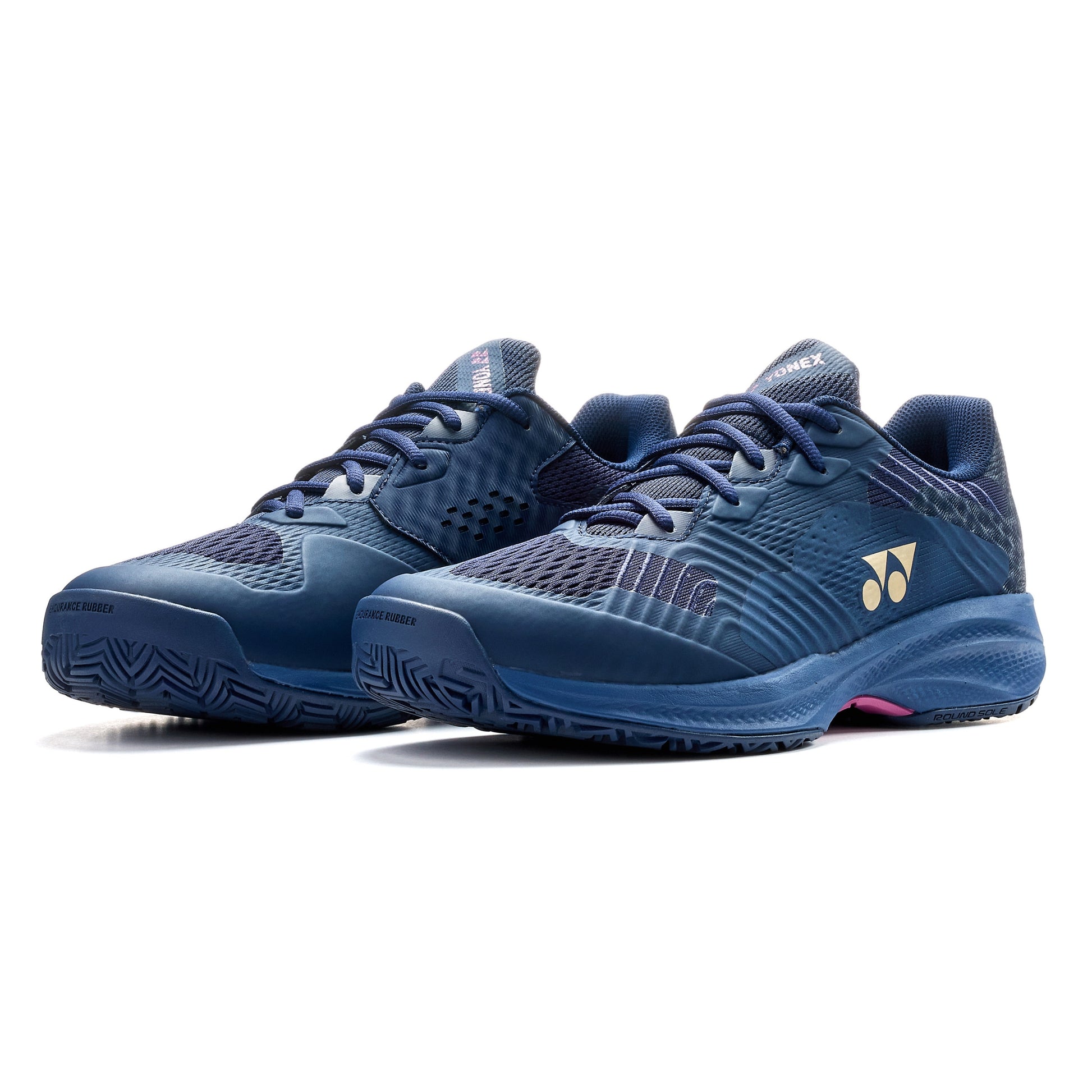 Pair of navy blue Yonex tennis shoes on a white background