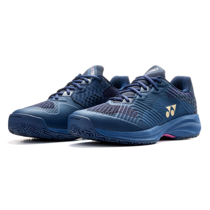 Pair of navy blue Yonex tennis shoes on a white background