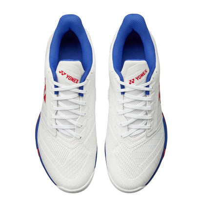 White tennis with blue soles and Yonex logo on a white background