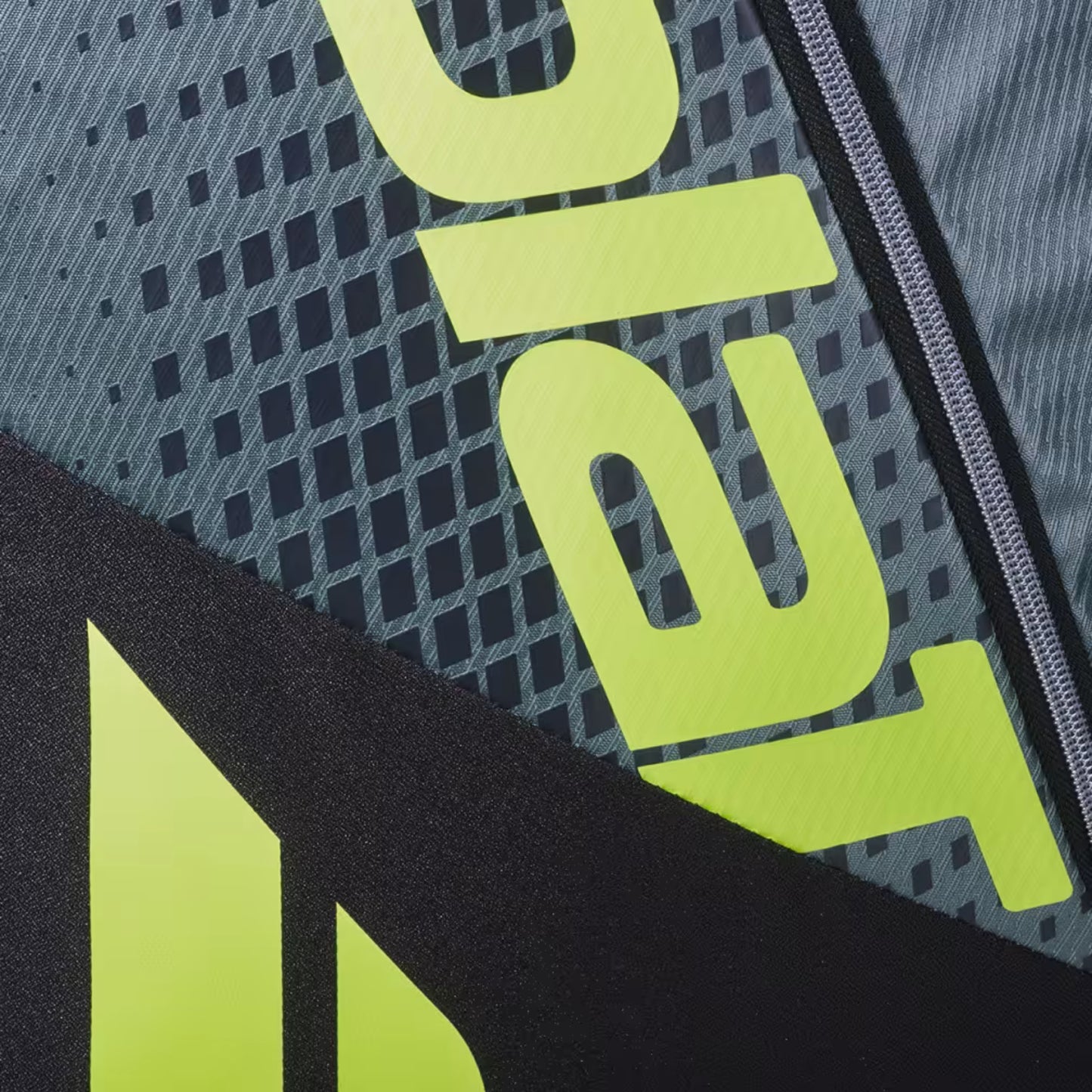 Close-up of a tennis bag with 'Babolat' branding on a textured background