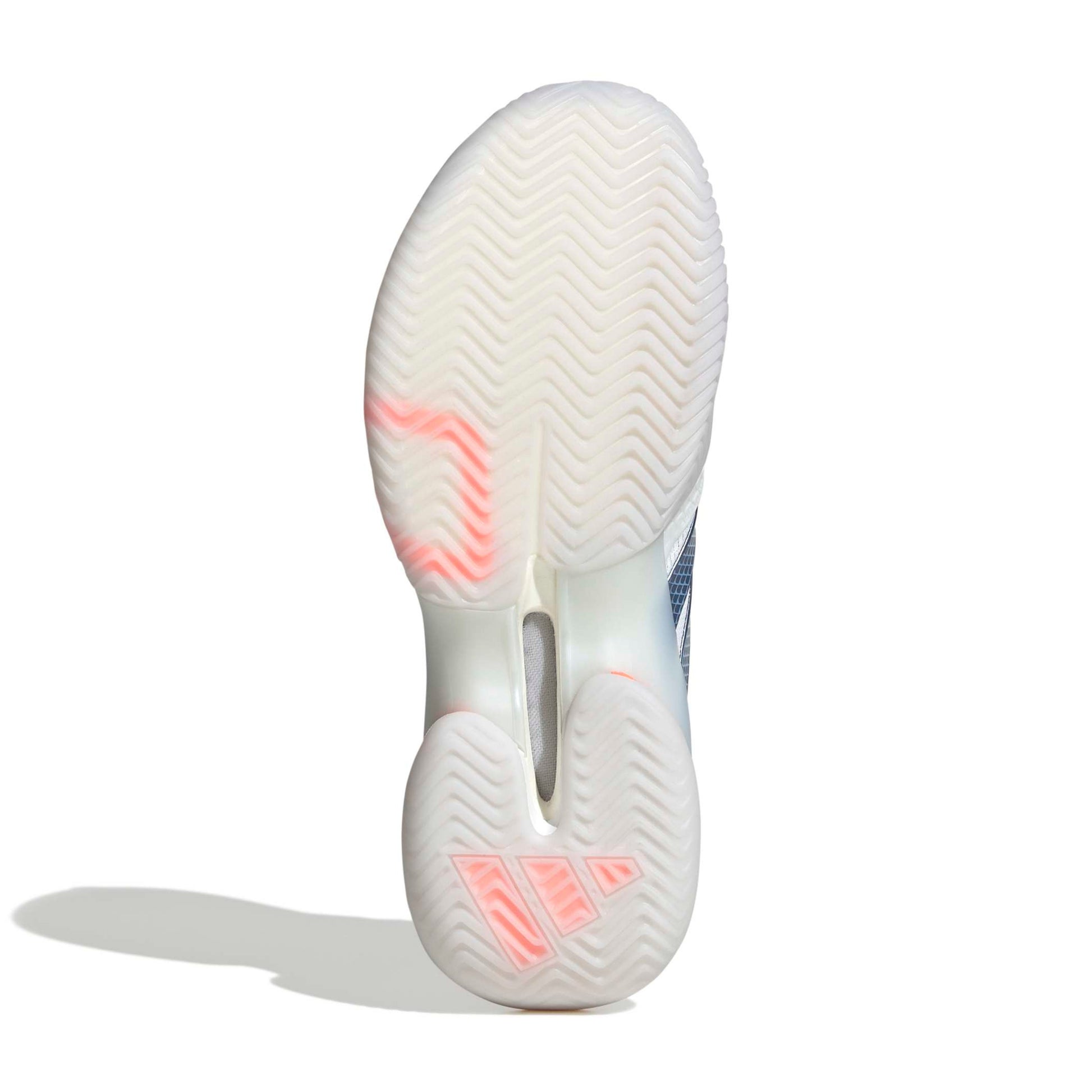 Close-up of a white adidas tennis shoe sole with pink accents on a white background