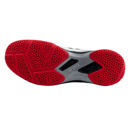 Yonex athletic shoe sole with red tread pattern on a white background