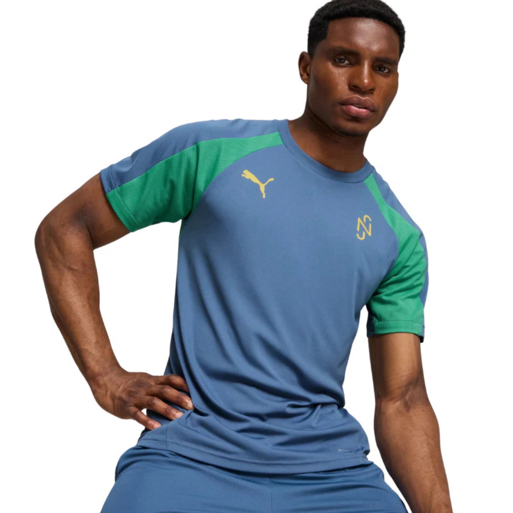 Man wearing a blue and green Puma soccer jersey with a visible brand logo on a white background