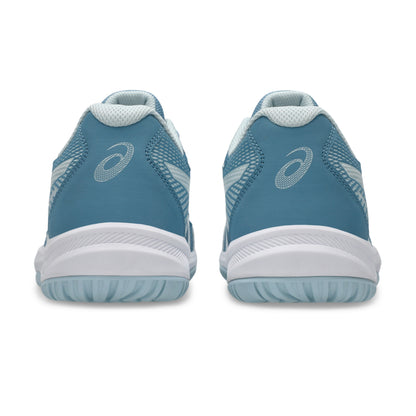 Pair of blue squash shoes with white soles on a white background
