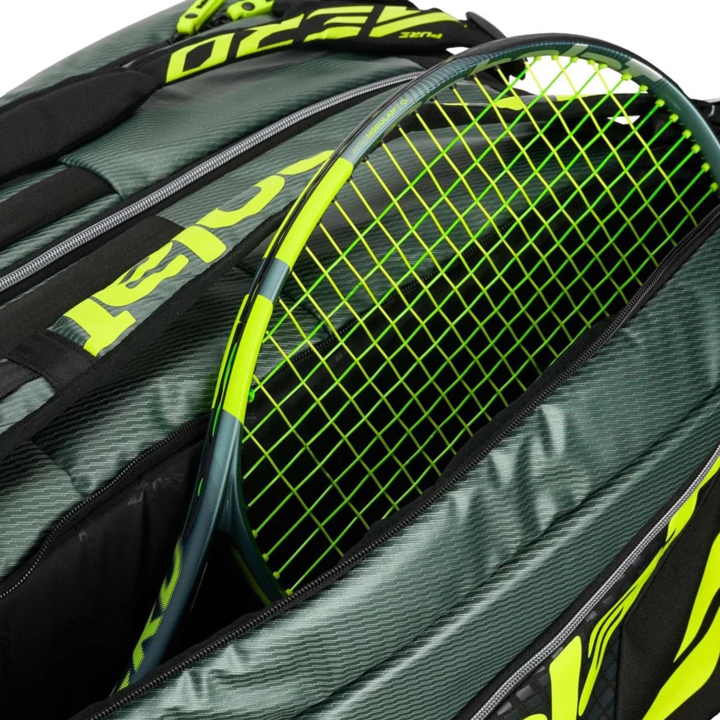 Tennis racket with green and black design inside a tennis bag