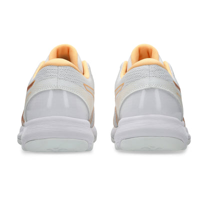 A pair of white netball shoes shown from the back, featuring light peach-orange lining and subtle orange accents on the heel straps, set against a plain white background.